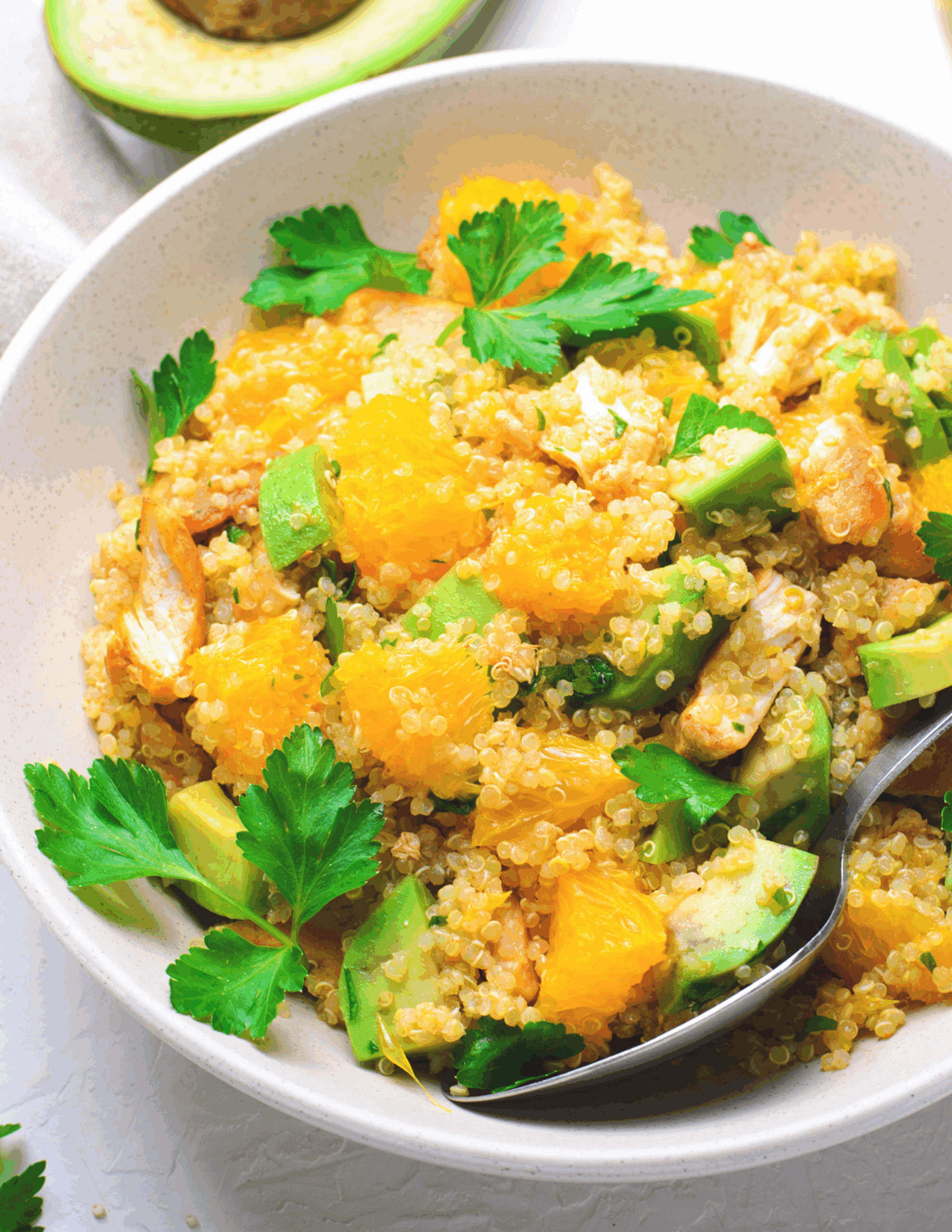 A vibrant bowl of Chicken & Pumpkin Quinoa featuring tender grilled chicken pieces, roasted pumpkin cubes, fluffy quinoa, and fresh herbs, all arranged beautifully on a rustic plate