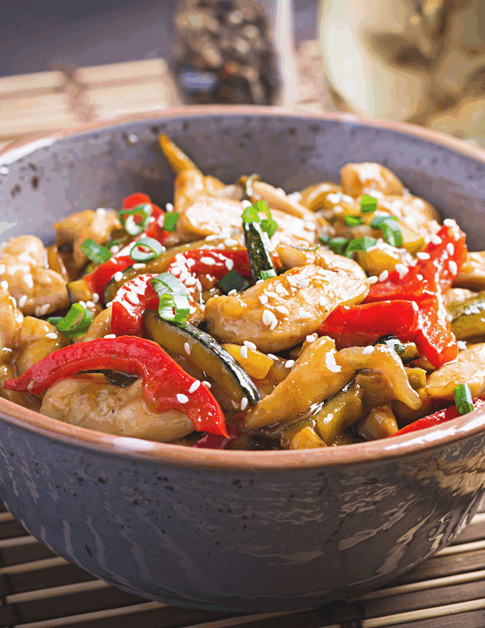 Colourful honey chicken stir fry featuring tender chicken bites, crisp vegetables, and a glossy honey-soy glaze, served in a vibrant bowl and garnished with sesame seeds.