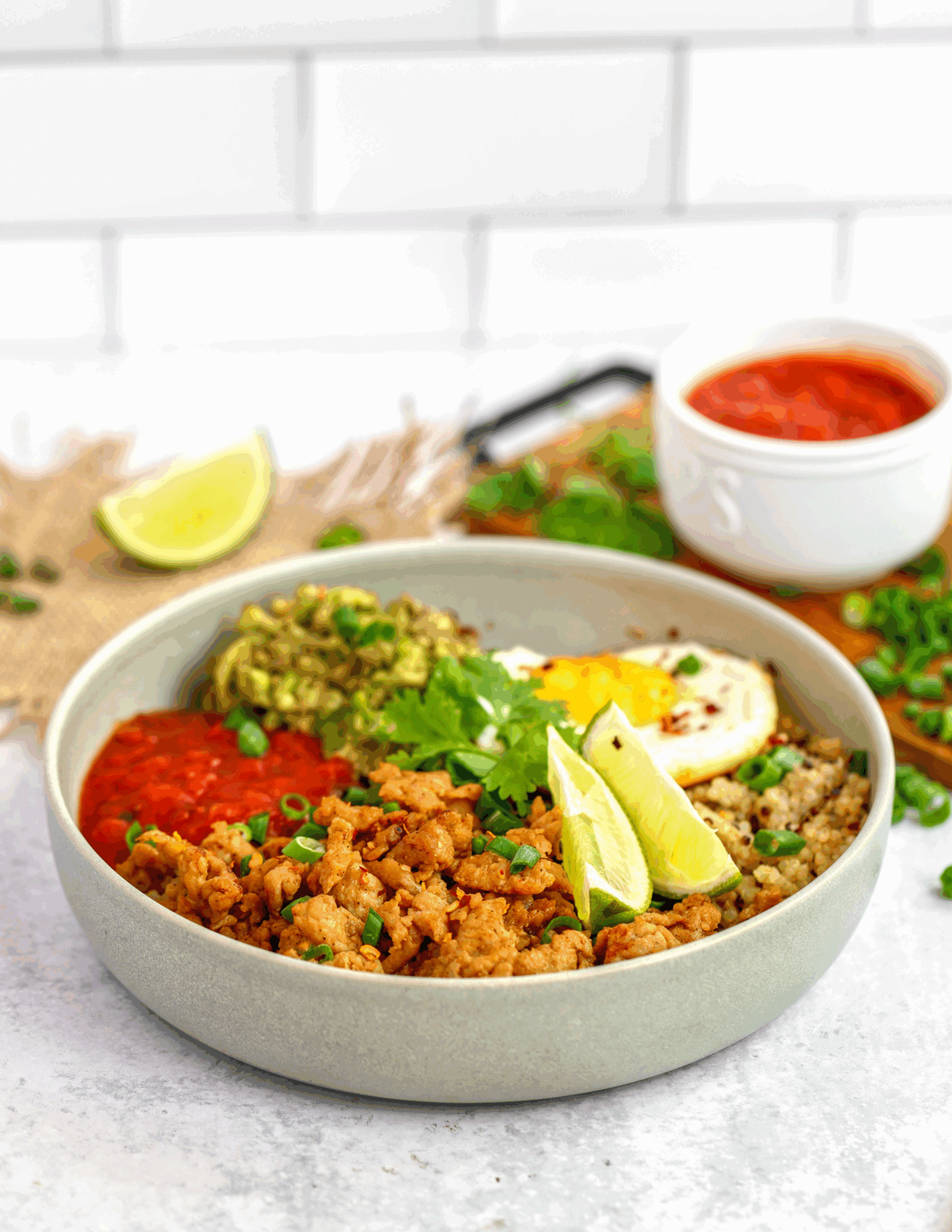 A vibrant Tex Mex Breakfast Salad Bowl filled with fresh vegetables, beans, avocado, and topped with a sunny-side-up egg.