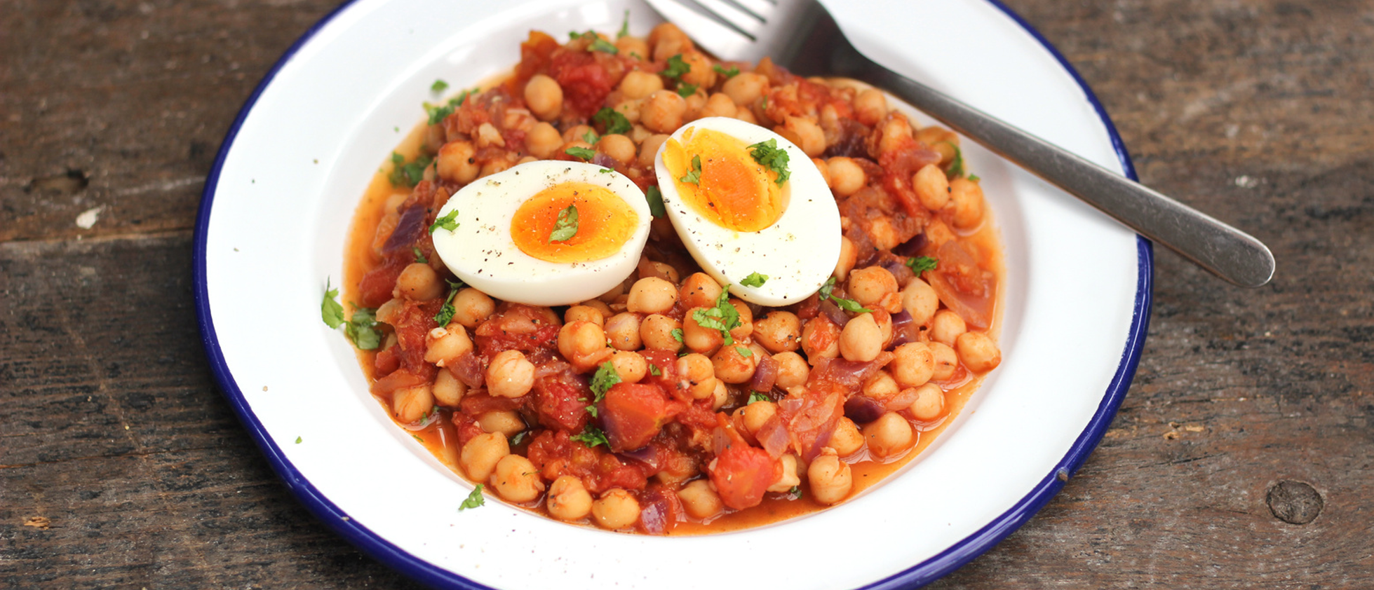 Spiced chickpea hash with roasted vegetables, fresh herbs, and a golden egg topping